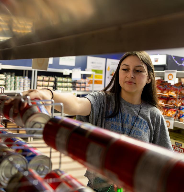 Student grabbing canned food