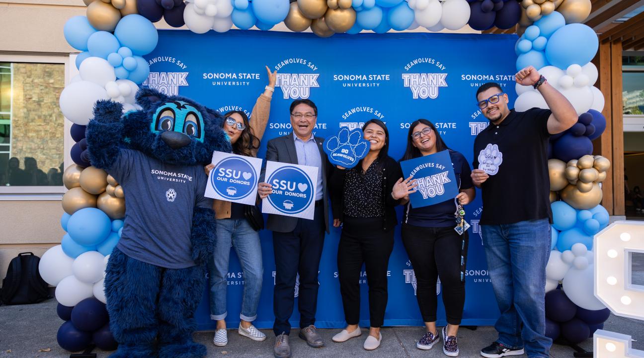 Students and President Lee holding signs that say SSU heart our donors