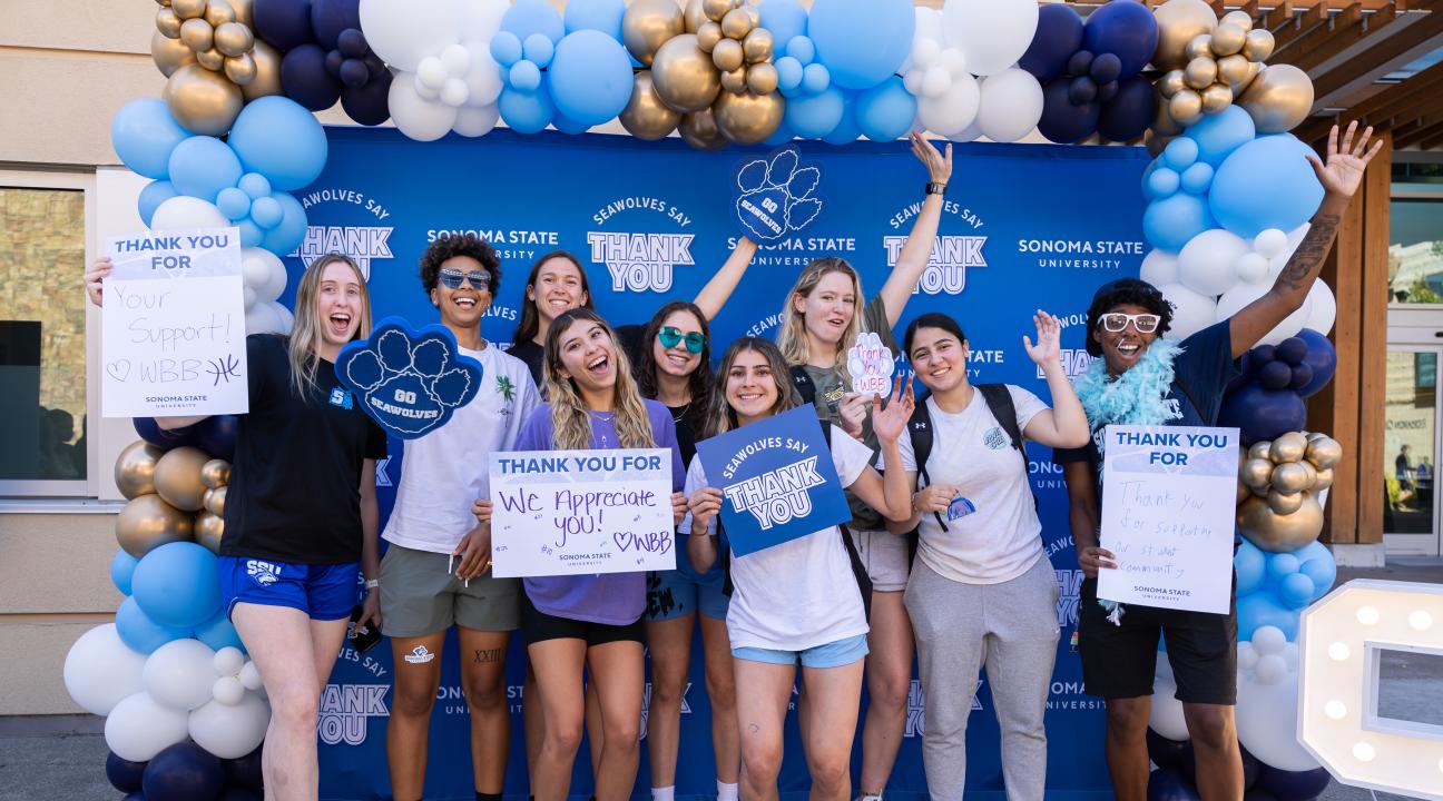 Group of students holding thank you signs