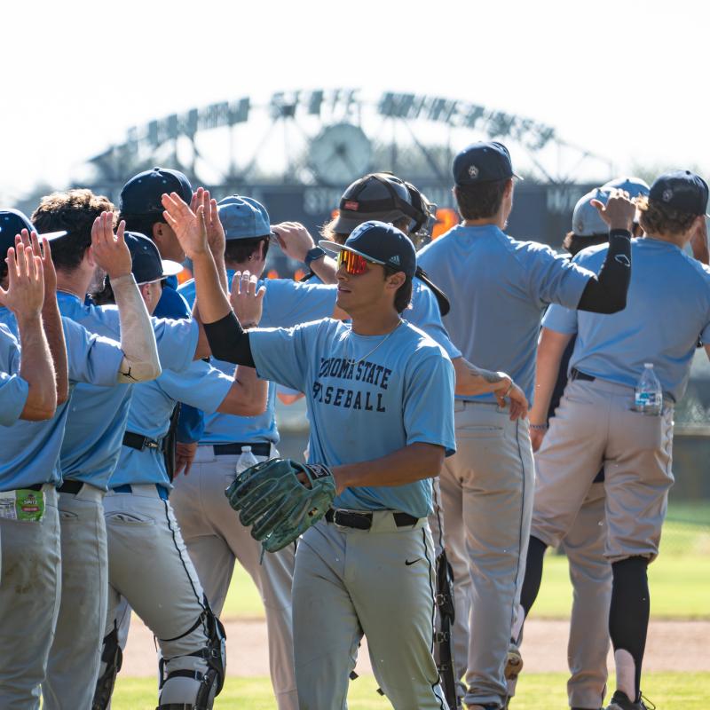 Students high fiving other teammates