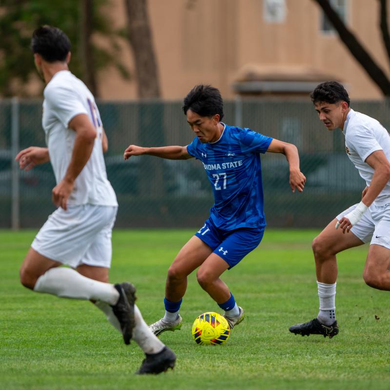 Student running with a soccer ball at their feet