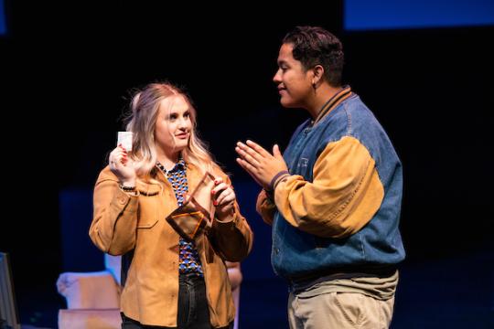 Students on stage talking to each other