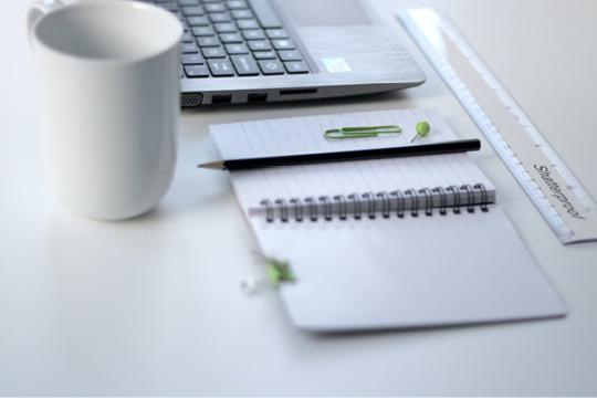Planner, coffee mug and laptop