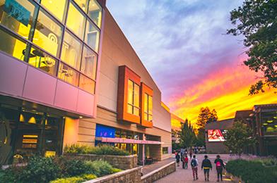 Student Center exterior of building with beautiful and colorful sunset in the background