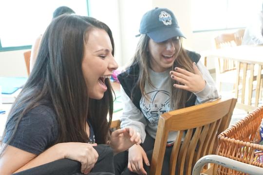 Students looking excited at a basket in the library