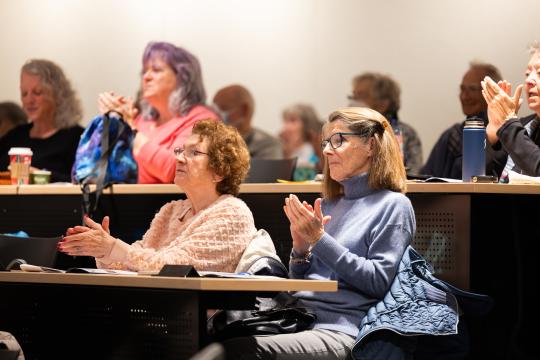 People in a classroom smiling