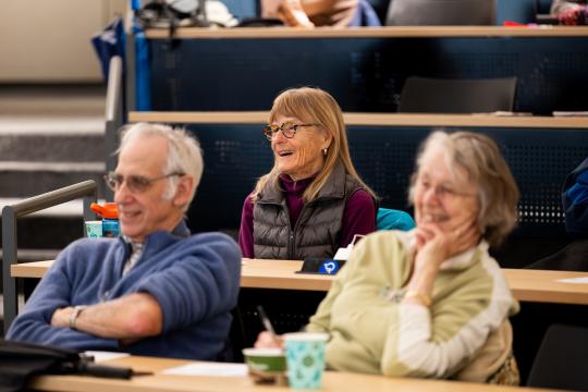 People in a classroom smiling