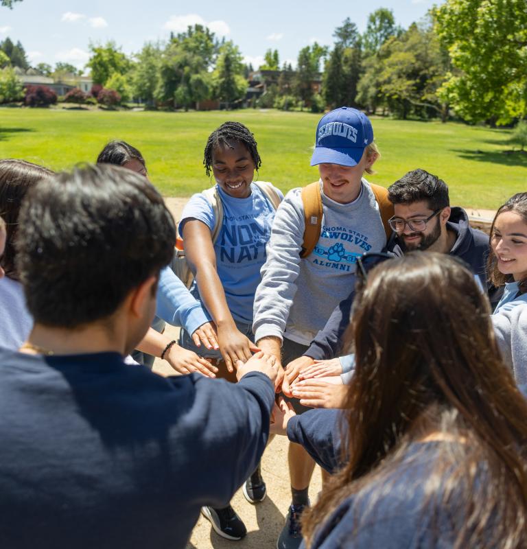 Students with hands together