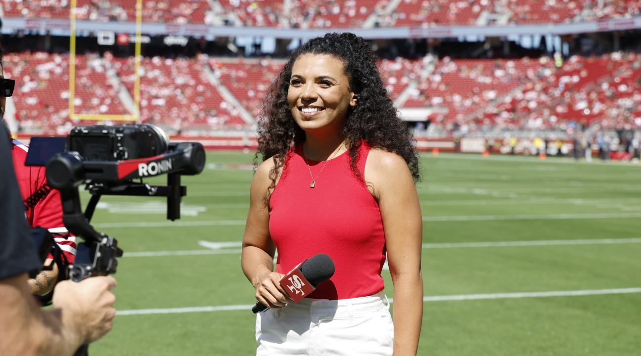 Aubrie Tolliver standing on Levi Stadium Field with a microphone in hand