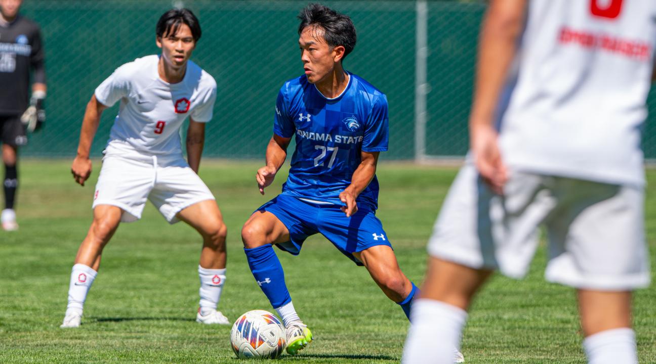 An SSU student kicking a ball while playing on the Men's Soccer team