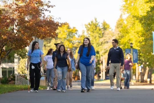 A group of students walking on the Sonoma State University campus 