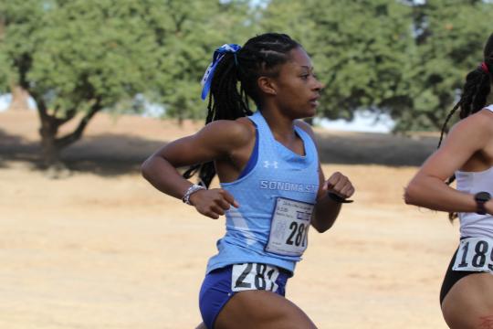 An SSU student running on the Women's Cross Country team