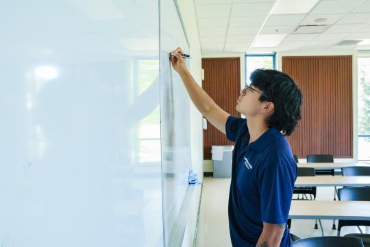 Carlos writing on whiteboard